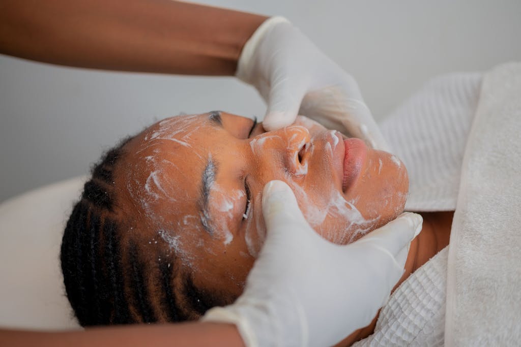 Relaxing facial massage at a spa in Abuja, Nigeria, promoting skincare and wellness.